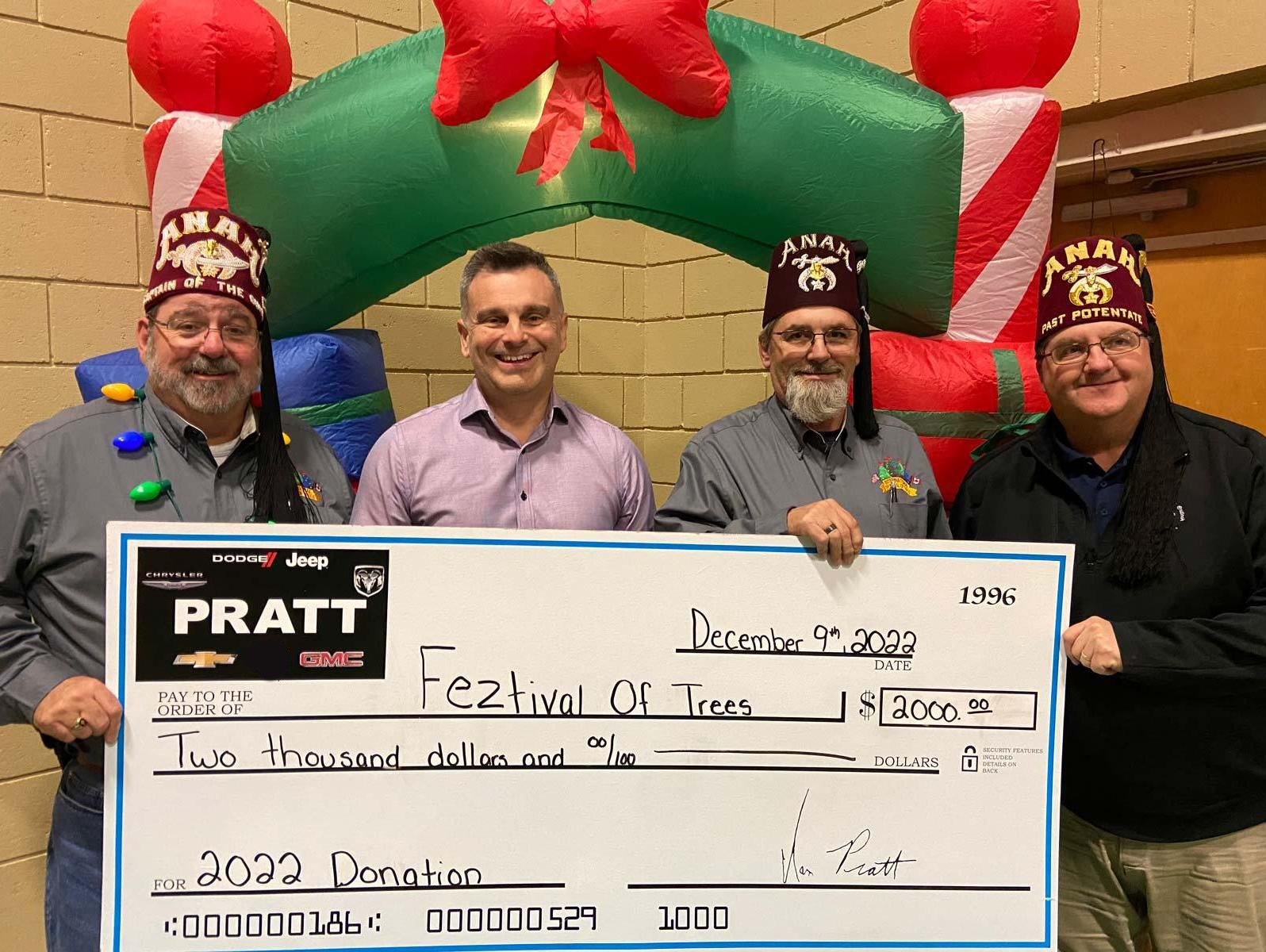 Four individuals proudly display a large