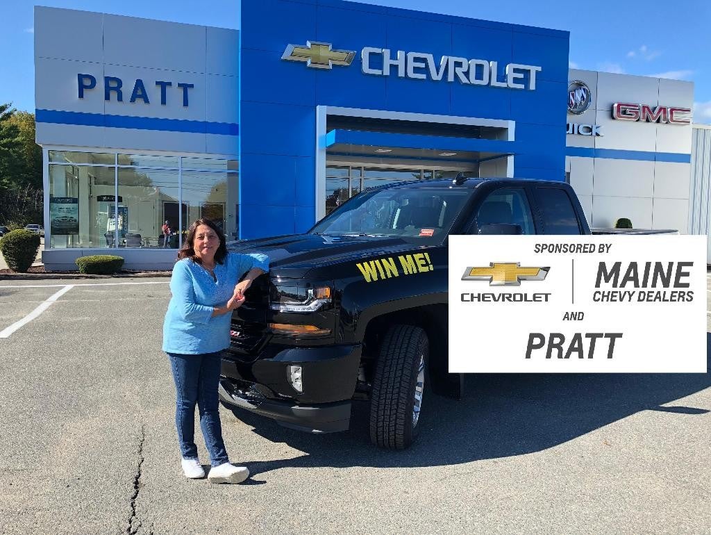 An individual proudly display a large check